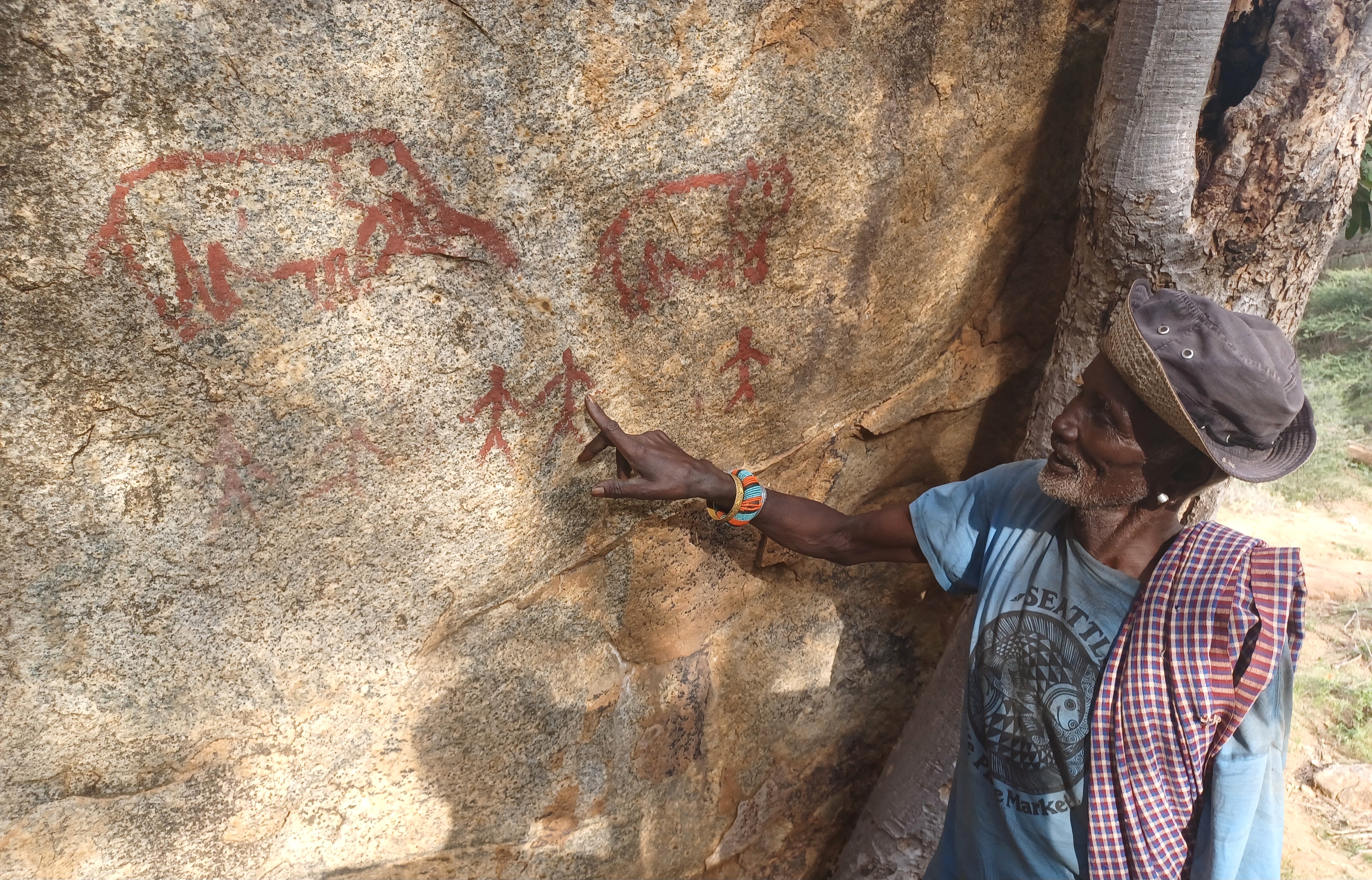 Loingeru Leparsore pointing at himself beside his fellow Lmurran in Soitnauno cave